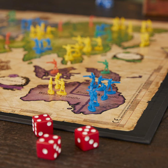 Risk board game with miniature figures and dice on the game board