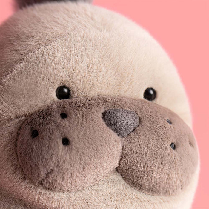 Close-up of a plush toy with a pink background