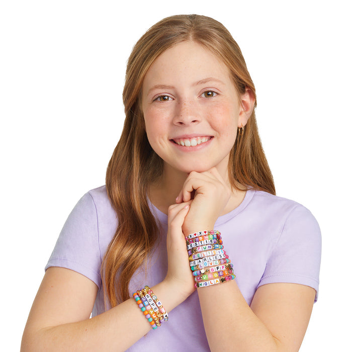 Young girl wearing colorful bracelets on a white background
