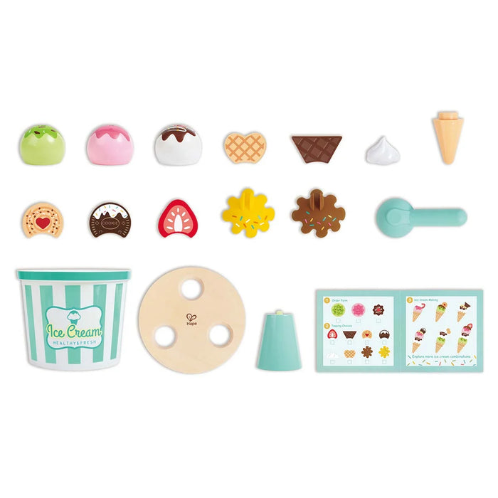 Set of toy ice cream cones and toppings on a white background