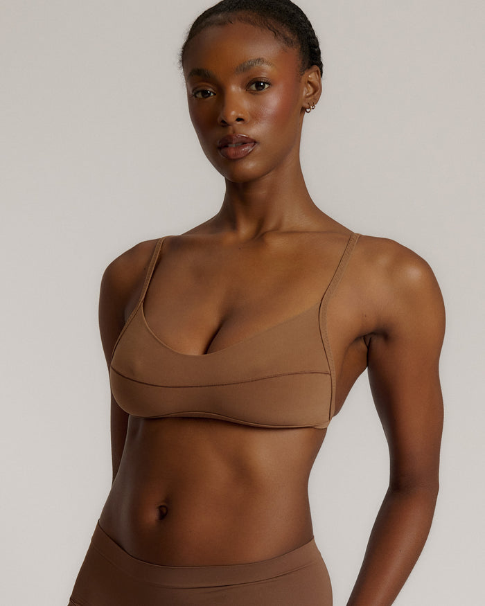 A woman wearing a brownz scoop system and matching bottoms