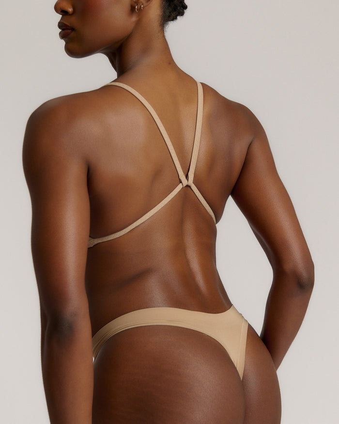 A woman wearing a light scoop system and matching bottoms
