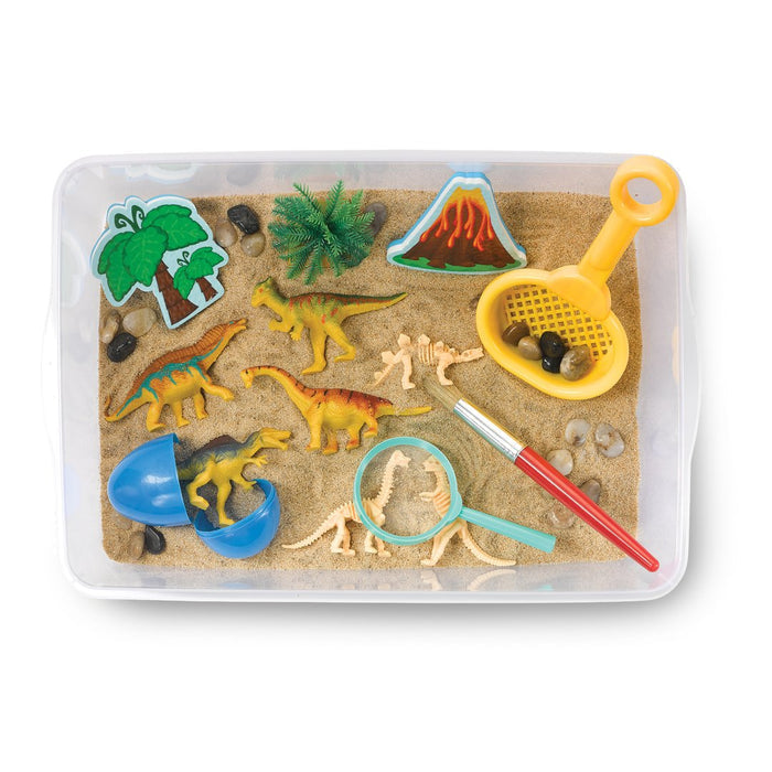 Contents of a dinosaur theme Sensory Bin on a white background