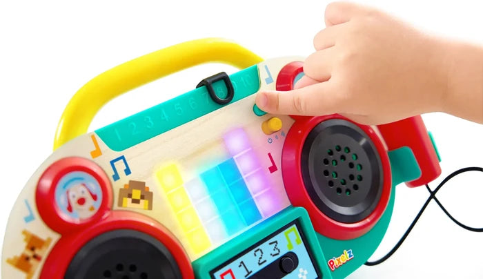 Colorful toy boombox with buttons and a hand interacting with it on a white background