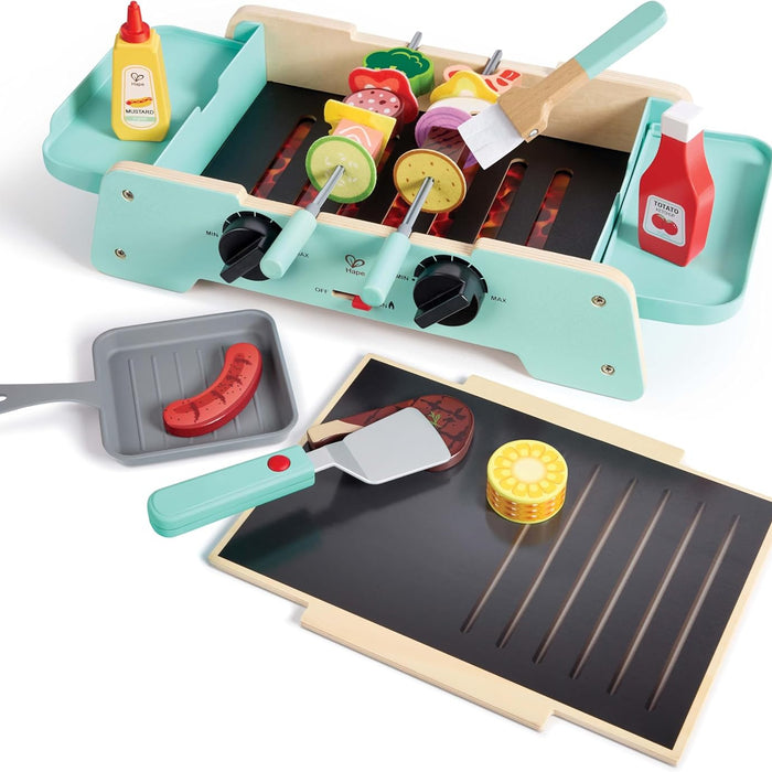 Toy barbecue set with various utensils and food items on a white background