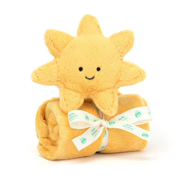 A soft plush toy resembling a black and cream puppy with perky ears, holding an un-stuffed square shaped soother, presented with a Baby Jellycat grosgrain ribbon.