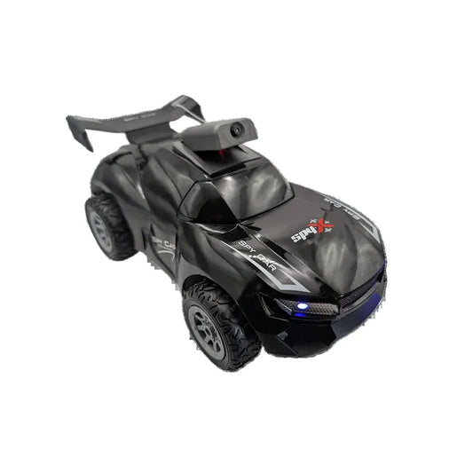 A black remote control off-road racing car with a rear spoiler, rugged tires, and 'SPEED X' branding on the hood, shown on a plain white background.