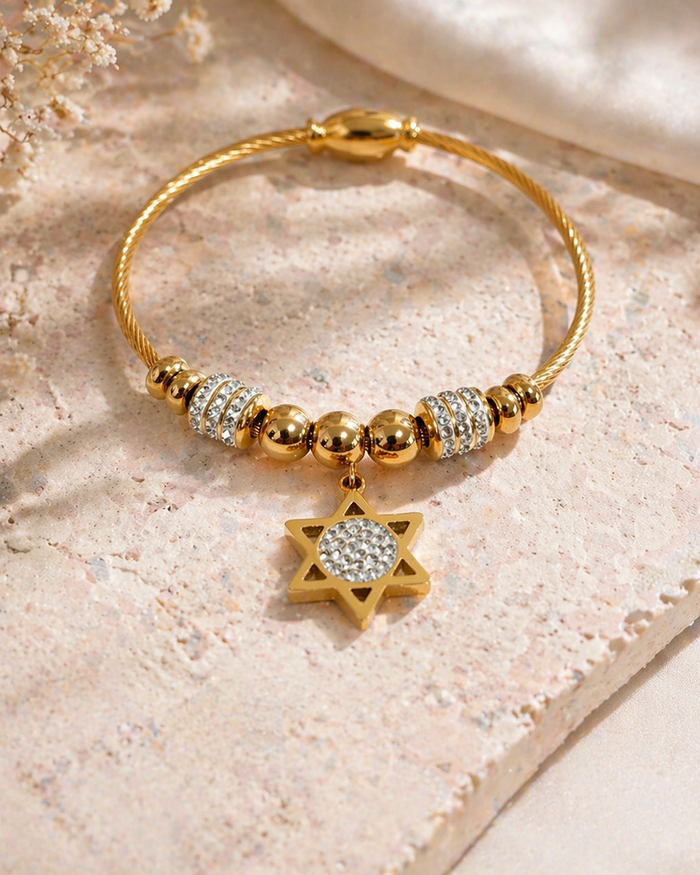 star of david gold bracelet stainless steel flat lay crystal charm close up