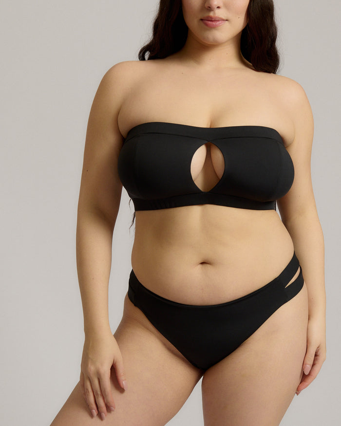Black strapless bikini worn by a person on a neutral background.