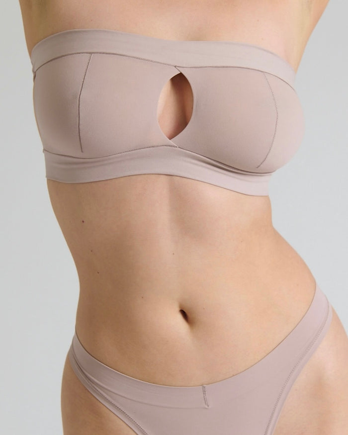 Beige bra and underwear set on a plain background