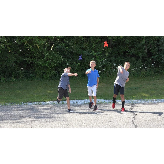 Three boys outside playing with their foam fliers