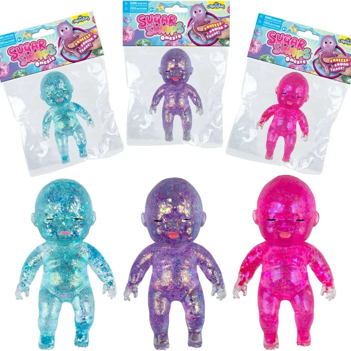 Three colorful squishy baby dolls in packaging on a white background