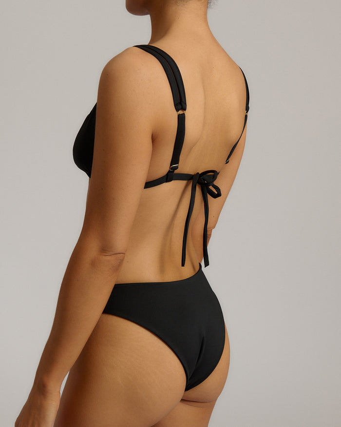 Black bikini with tie-back design on a neutral background
