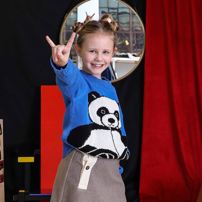 Girl wearing a panda sweater while smiling at the camera