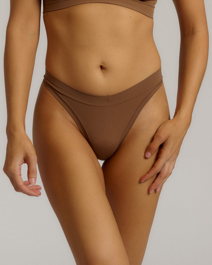 Woman standing wearing the Thong in brownz