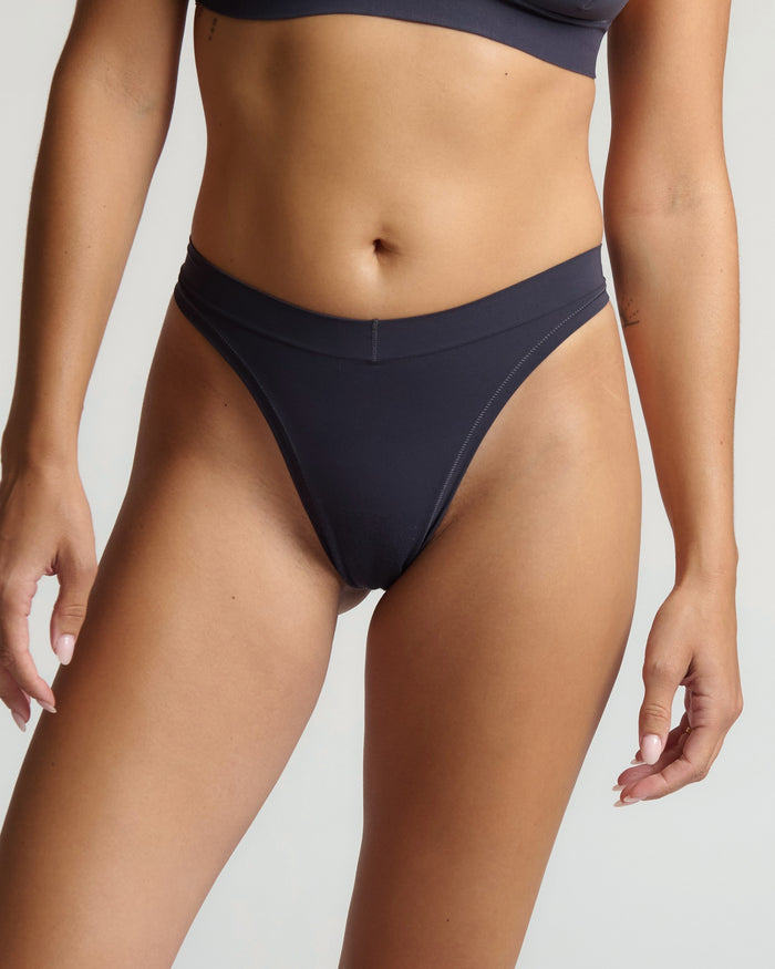 Person wearing gray underwear on a plain background