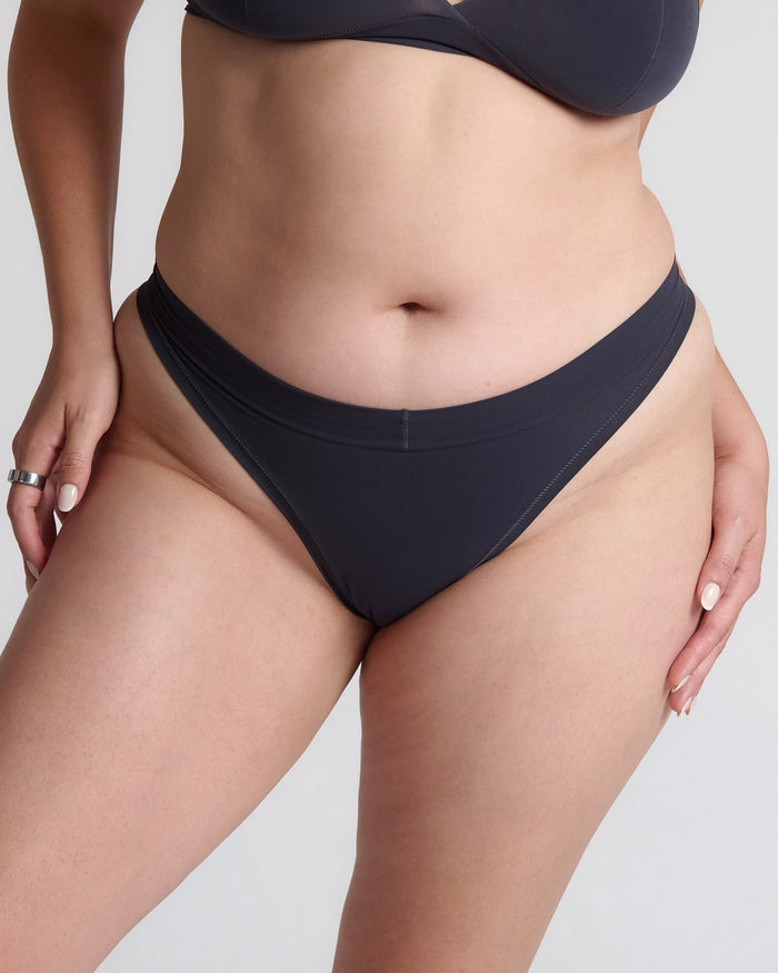 Person wearing gray underwear on a plain background
