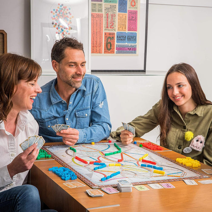 Family playing Ticket To Ride Board Game