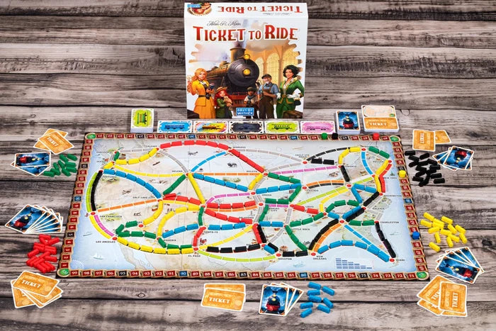 Board game 'Ticket to Ride' with components on a wooden surface