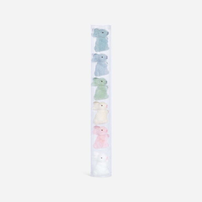 Set of pastel-colored plush toys in a clear holder on a white background