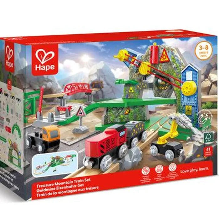 Hape Treasure Mountains Train Set toy box, showing a colorful train playset with a red train, green tracks, mountains, and construction elements on a white background.