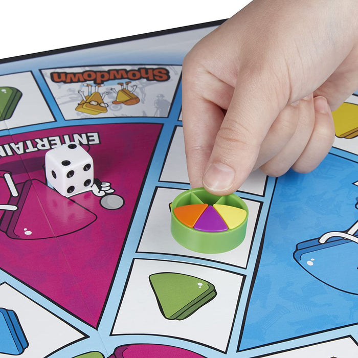 Close up of game pieces and a die on the Trivial Pursuit Family edition game board