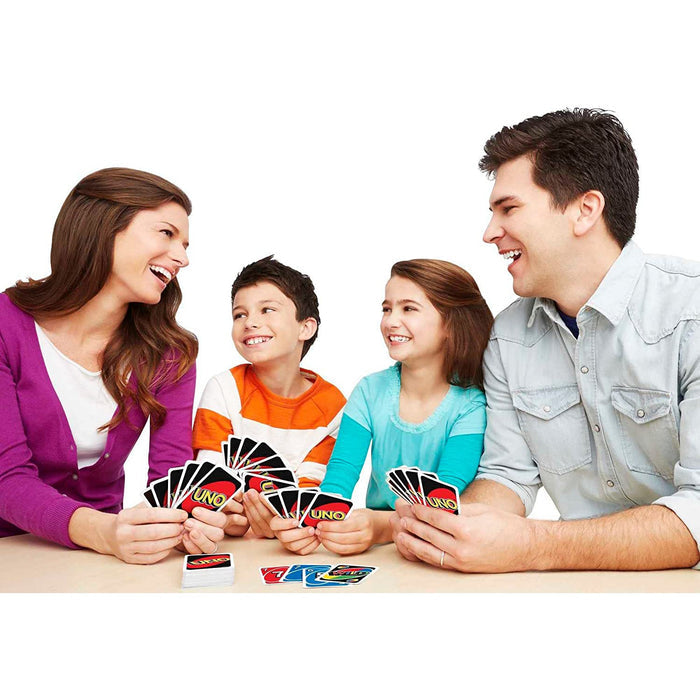 Family of four playing Uno on a white background