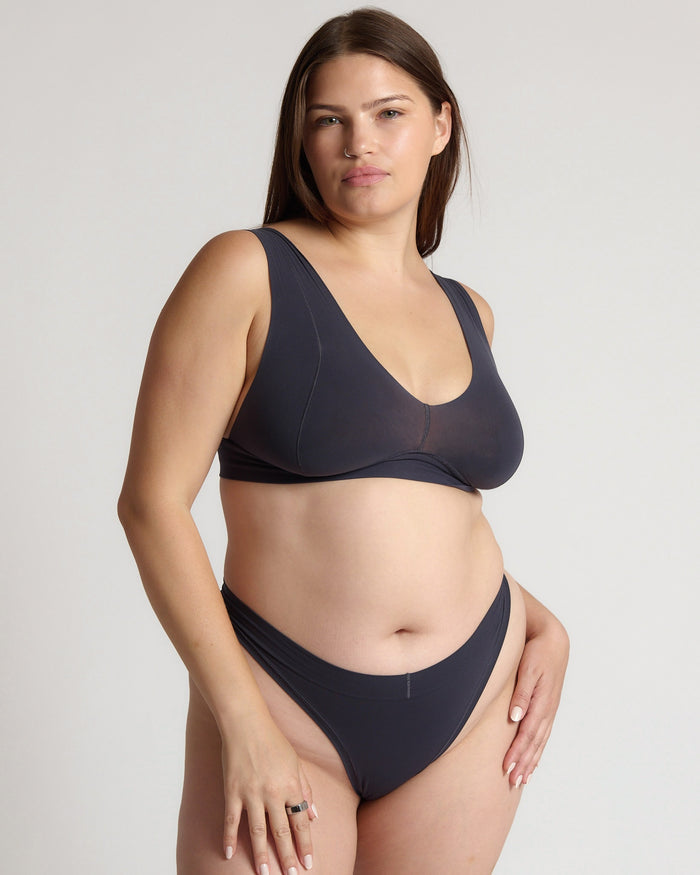 Woman wearing a gray vii system against a plain background
