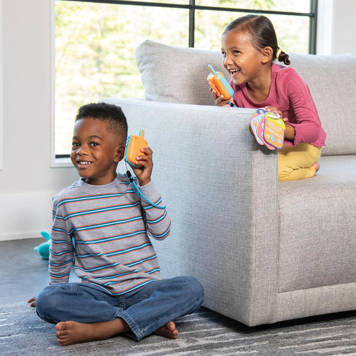 Two children playing with toys on a couch in a living room.