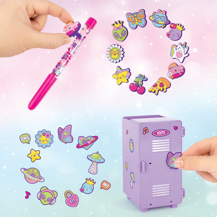 A children's craft kit featuring a small lavender locker with a butterfly door, a pink glitter pen, and colorful decorative stickers shaped like butterflies, flowers, stars, and planets. Two hands are shown interacting with the toy, and the background is a soft pastel gradient with sparkles.